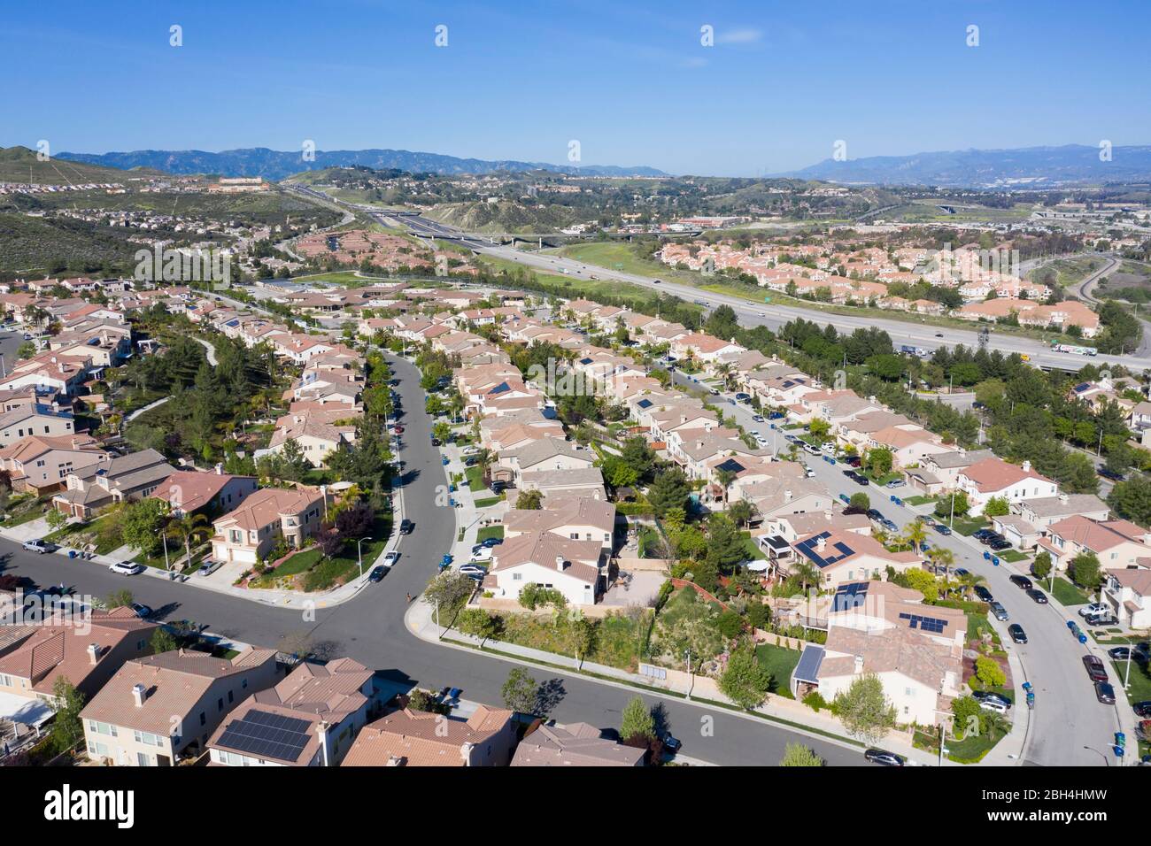 Aerial view above Canyon Country sprawl rows of homes north of Los Angeles in Santa Clarita, California Stock Photo
