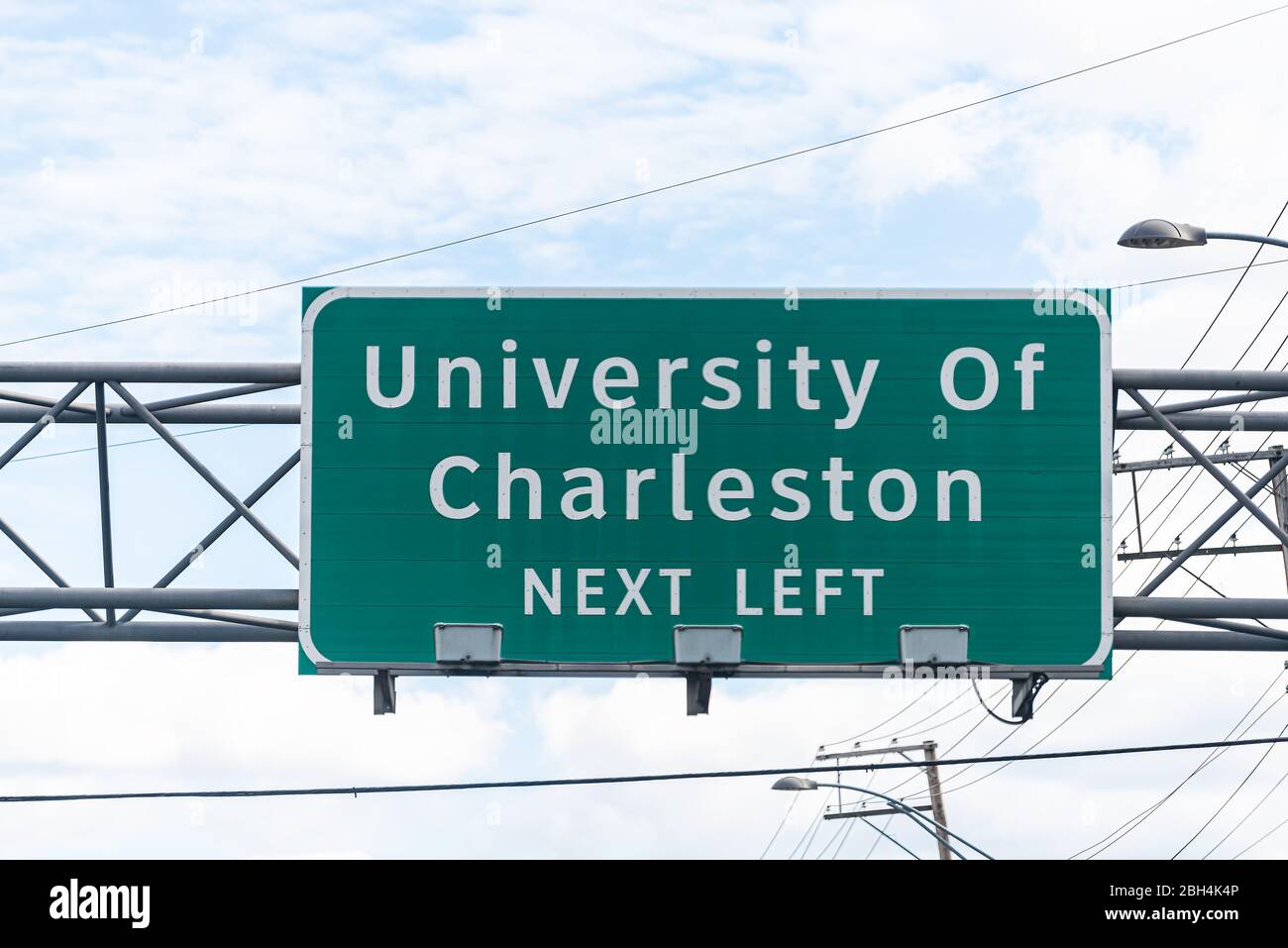 Charleston, USA University entrance direction sign in West Virginia capital city center for education isolated on highway against sky Stock Photo