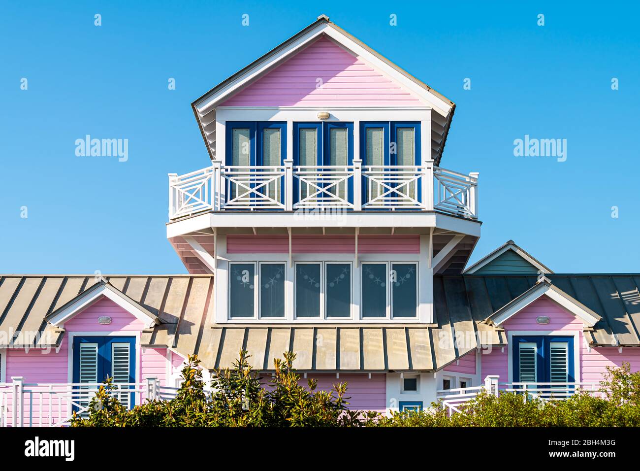 Wooden house tower architecture by beach ocean nobody in Florida view during sunny day with pink color of new urbanism design and blue sky Stock Photo
