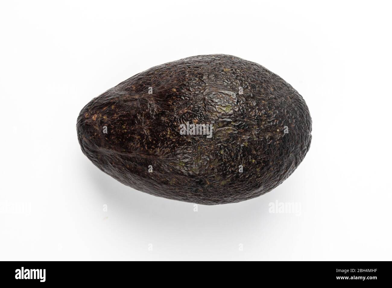 Ripe avocado isolated on blue background Stock Photo