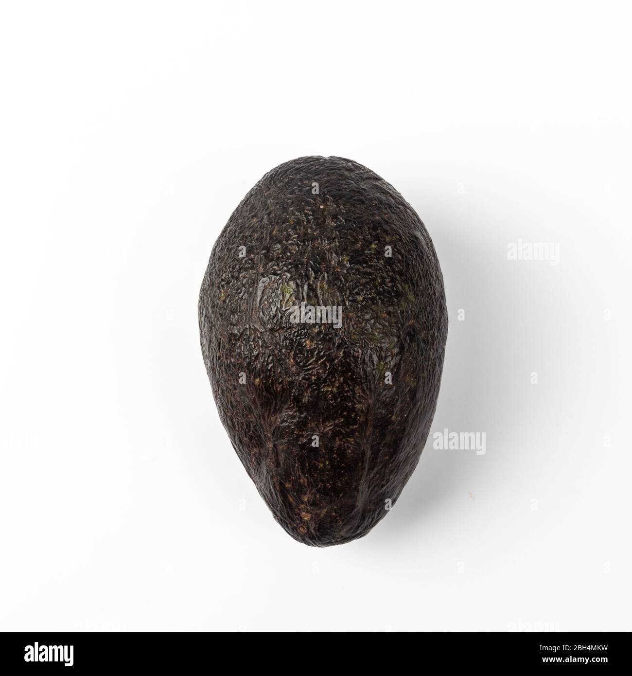 Ripe avocado isolated on blue background Stock Photo