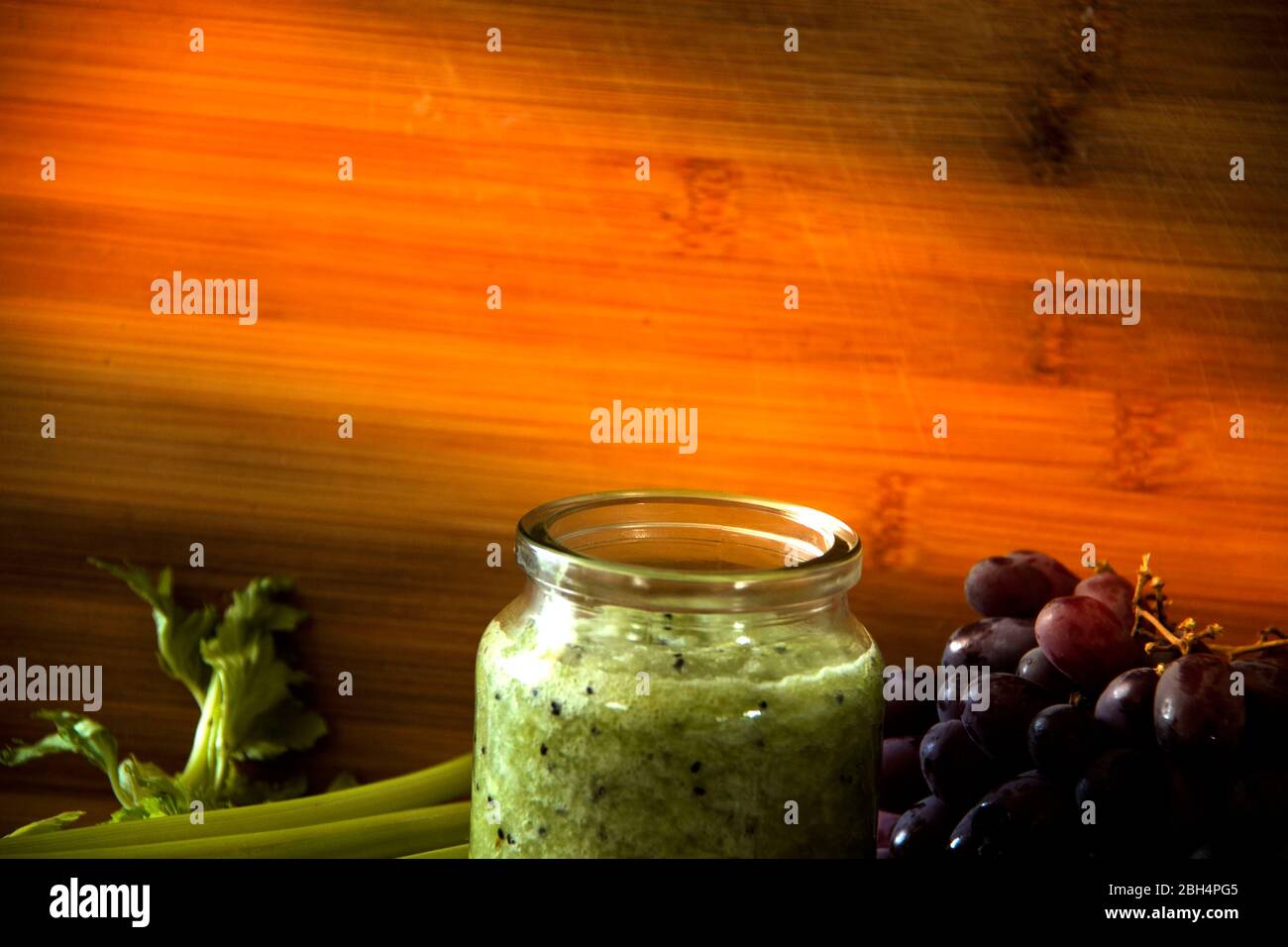 Green detox juice in glass jar. Healthy eating concept. Vegetable and fruit smoothie. Stock Photo