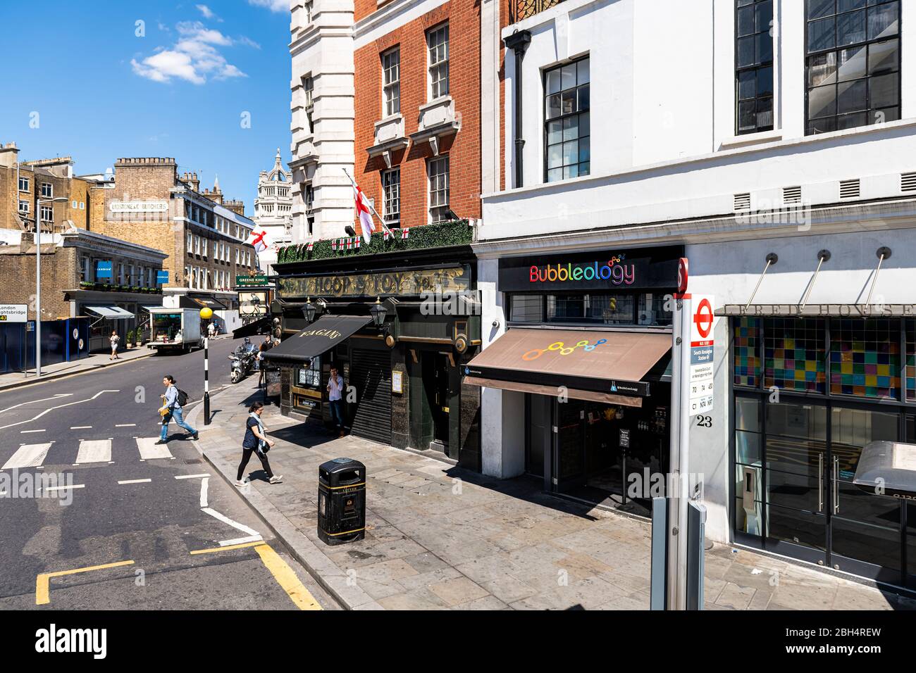 London, UK - June 22, 2018: Neighborhood district of south Kensington with architecture and Bubbleology restaurant and people on street road sidewalk Stock Photo