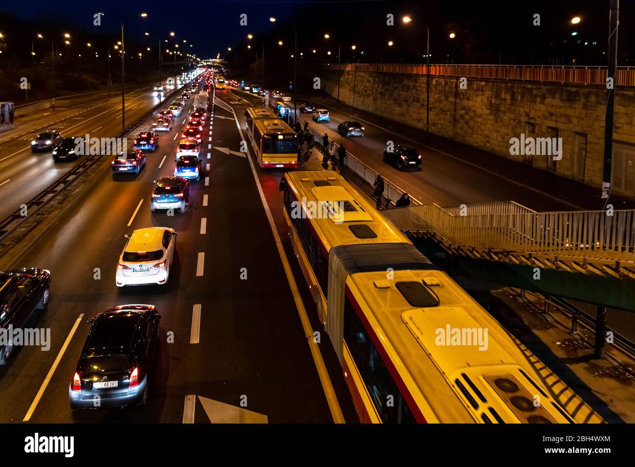 Warsaw, Poland - December 20, 2019: Above high angle aerial view of Aleja Armii Ludowej street avenue in Warszawa at night with traffic cars, people s Stock Photo