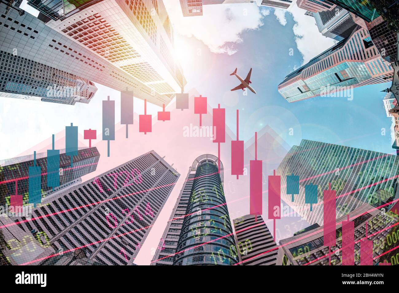 Economic recession concept showing declining stock chart and plane flying over modern business skyscraper buildings in Singapore's financial district. Stock Photo