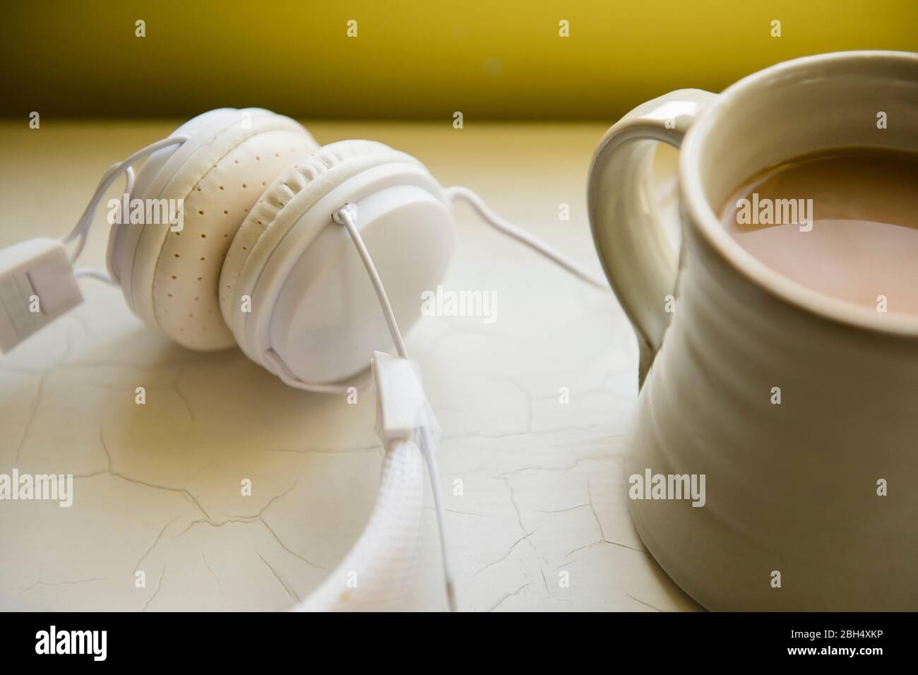 White headphones and cup of coffee Stock Photo