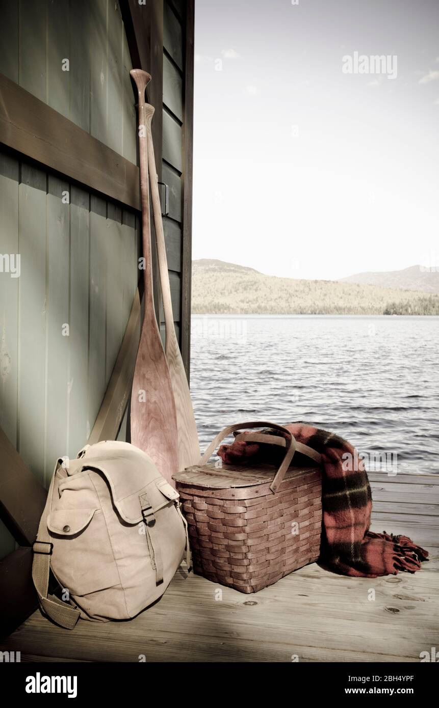 Oars and picnic supplies by lake Stock Photo