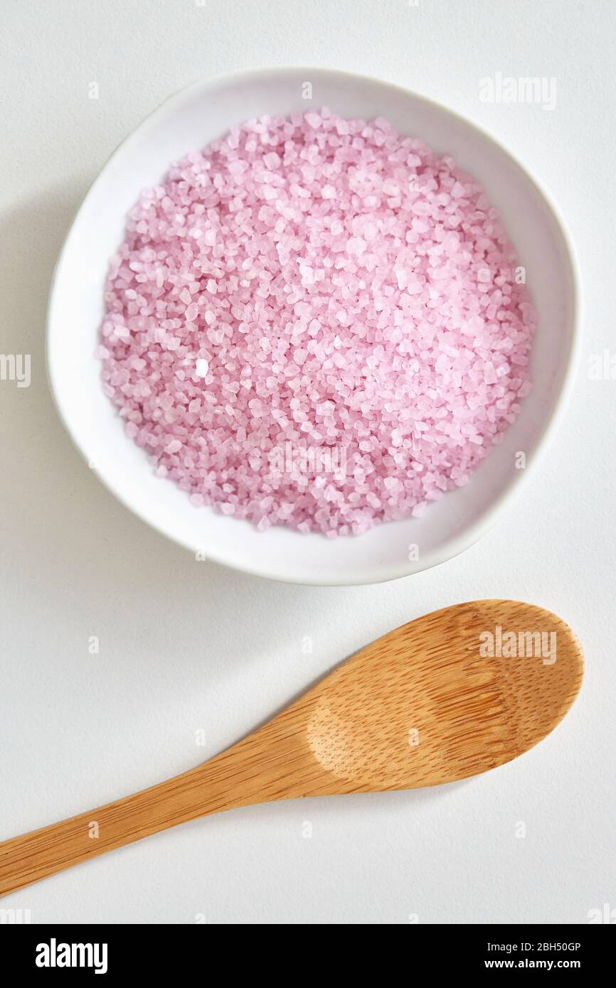 Bath salt in bowl and wooden spoon Stock Photo