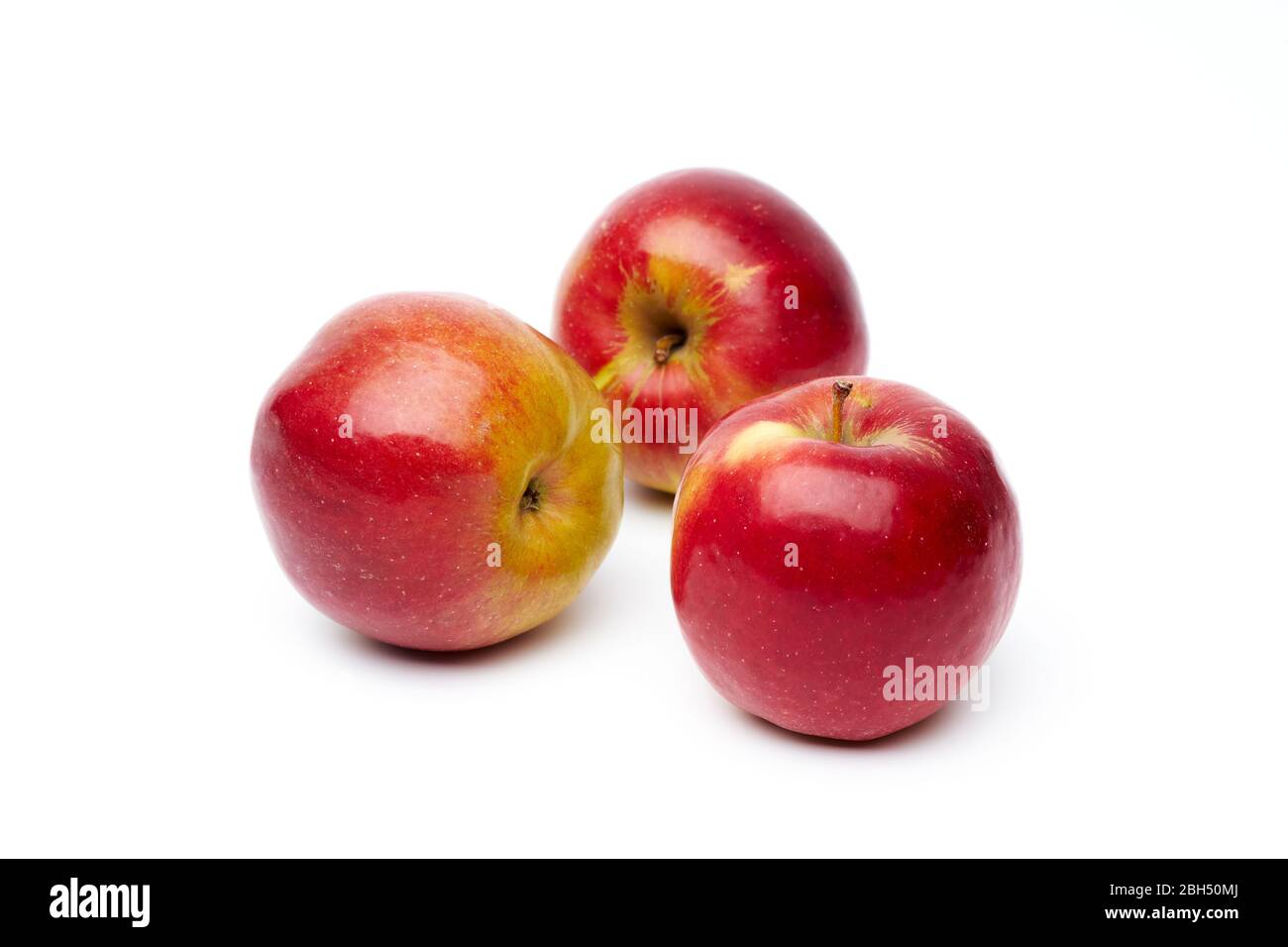 Three ripe red apples isolated on a white background. Stock Photo