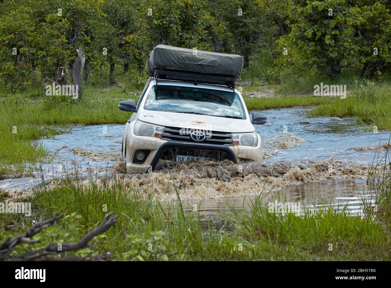 4x4 camper driving on flooded track, Moremi Game Reserve, Botswana, Africa Stock Photo
