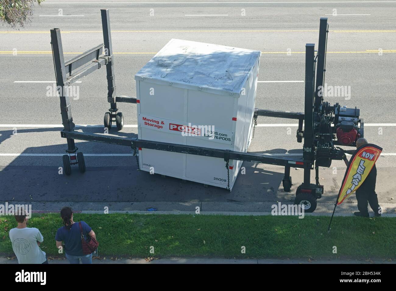 Los Angeles, CA / USA - April 21, 2020: A PODS company moving and storage small container cube is shown being moved in place, using a hydraulic lift. Stock Photo