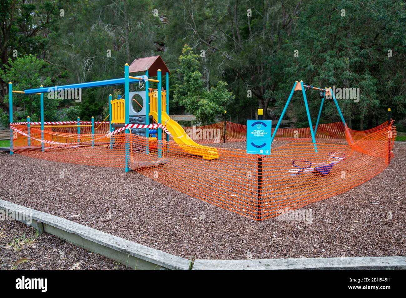 Due to COVID-19 pandemic, a public children's playground is closed and fenced off to the public. Stock Photo