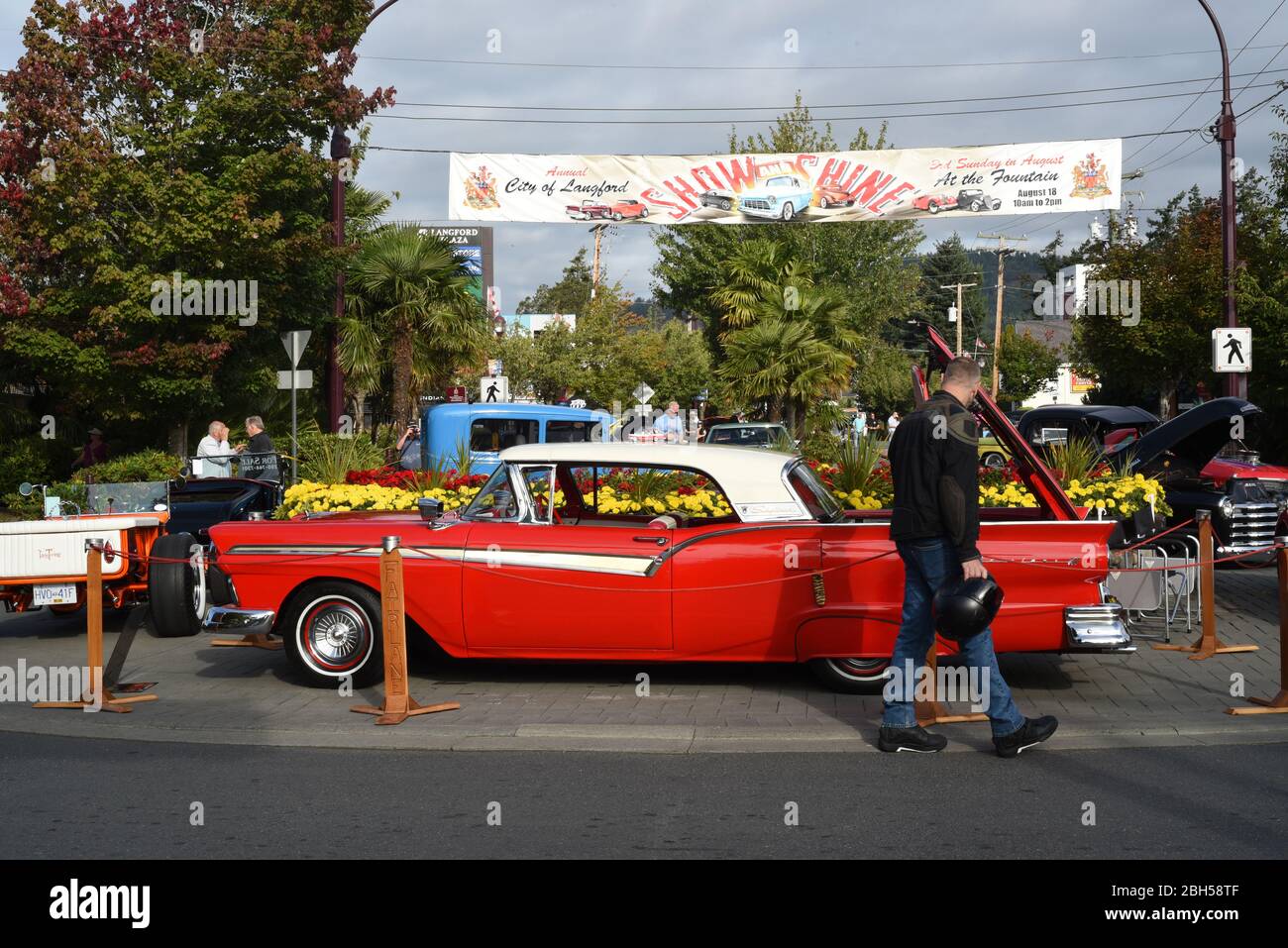 Restored antique, classic and custom collector cars line Goldstream Avenue in Langford, British Columbia, Canada on Vancouver Island during the annual Stock Photo