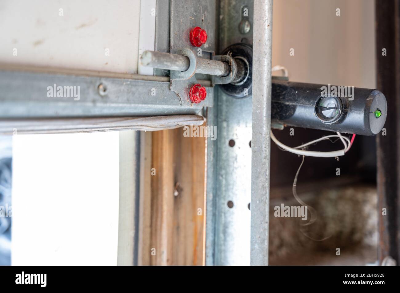 One receptor eye of a garage door safety sensor that stops action if the beam is crossed Stock
