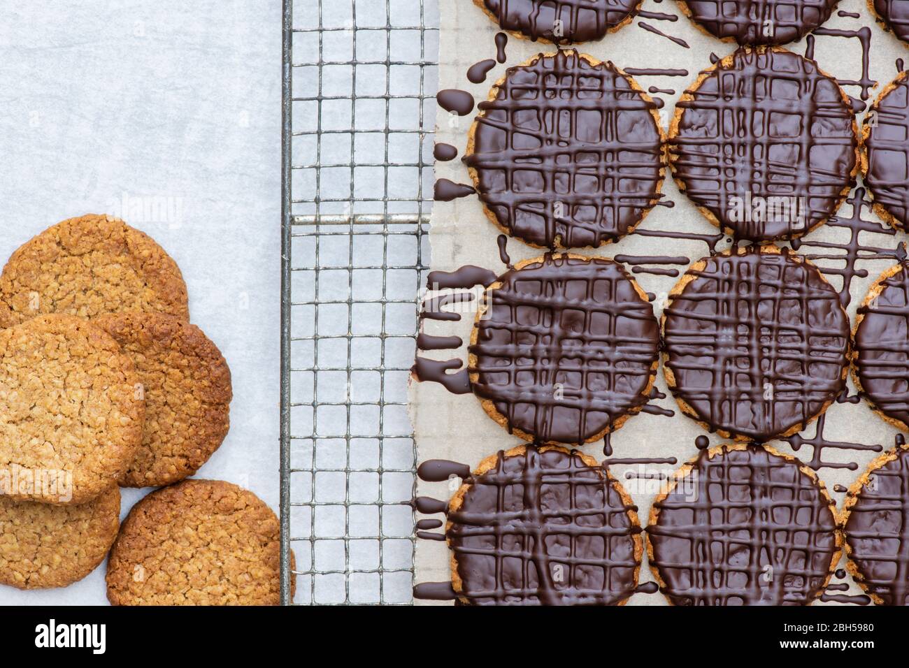 Homemade dark chocolate covered hobnob biscuits on a wire rack Stock