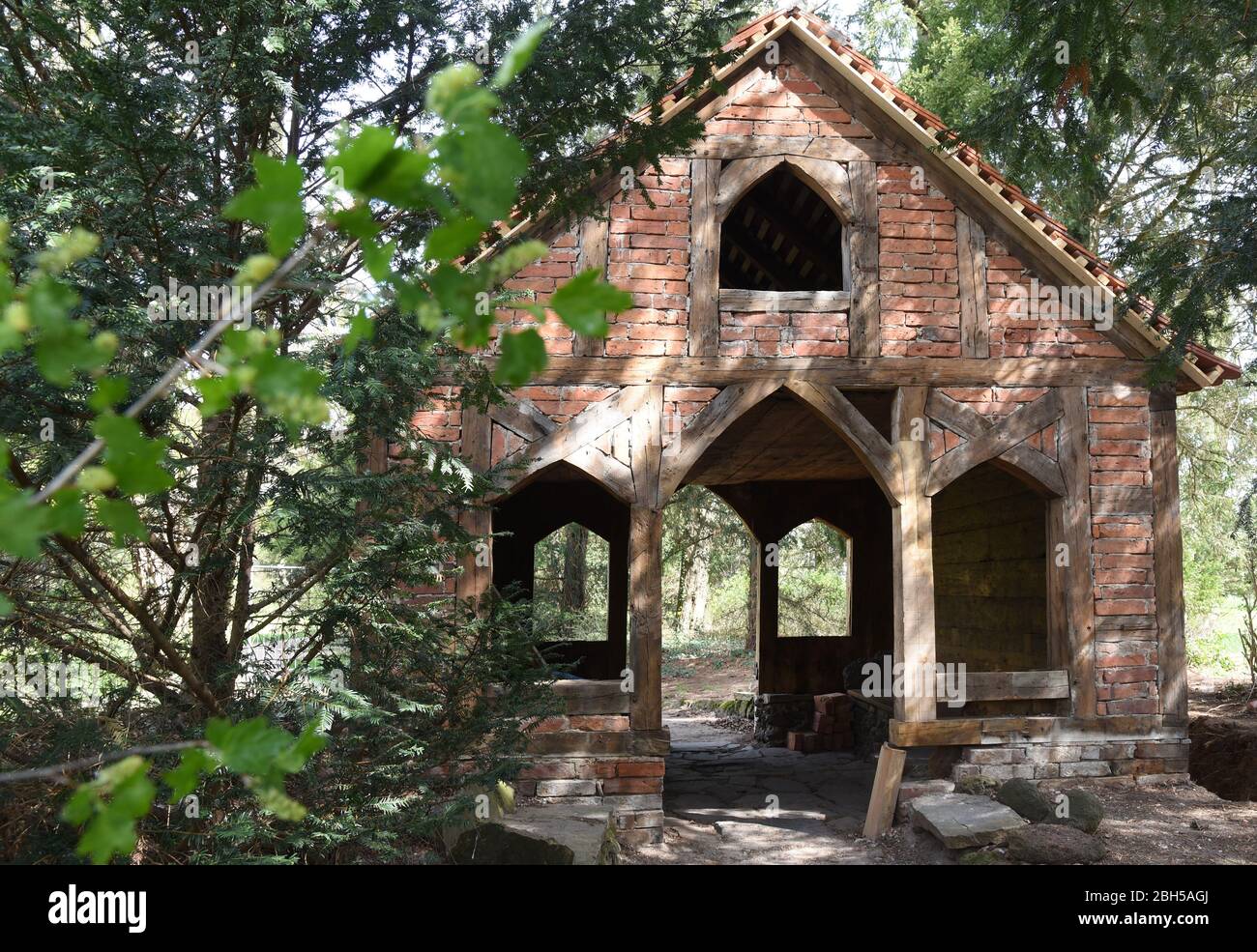 16 April 2020, Saxony-Anhalt, Wörlitz: Without its bark - root - cover, the bathhouse of Prince Leopold III Friedrich Franz von Anhalt Dessau (1740-1817), built some 235 years ago, stands in Wörlitz Park. The half-timbered house, which is actually clad in bark wood and is known as Borkenhäuschen or Wurzelhütte, is currently being restored. Severe damage to the load-bearing structure, as well as to the outer bark and inner decorative cladding attached to it, will have to be repaired in the coming weeks. The Wörlitz Park is part of today's UNESCO World Heritage Site Dessau-Wörlitz Garden Kingdom Stock Photo