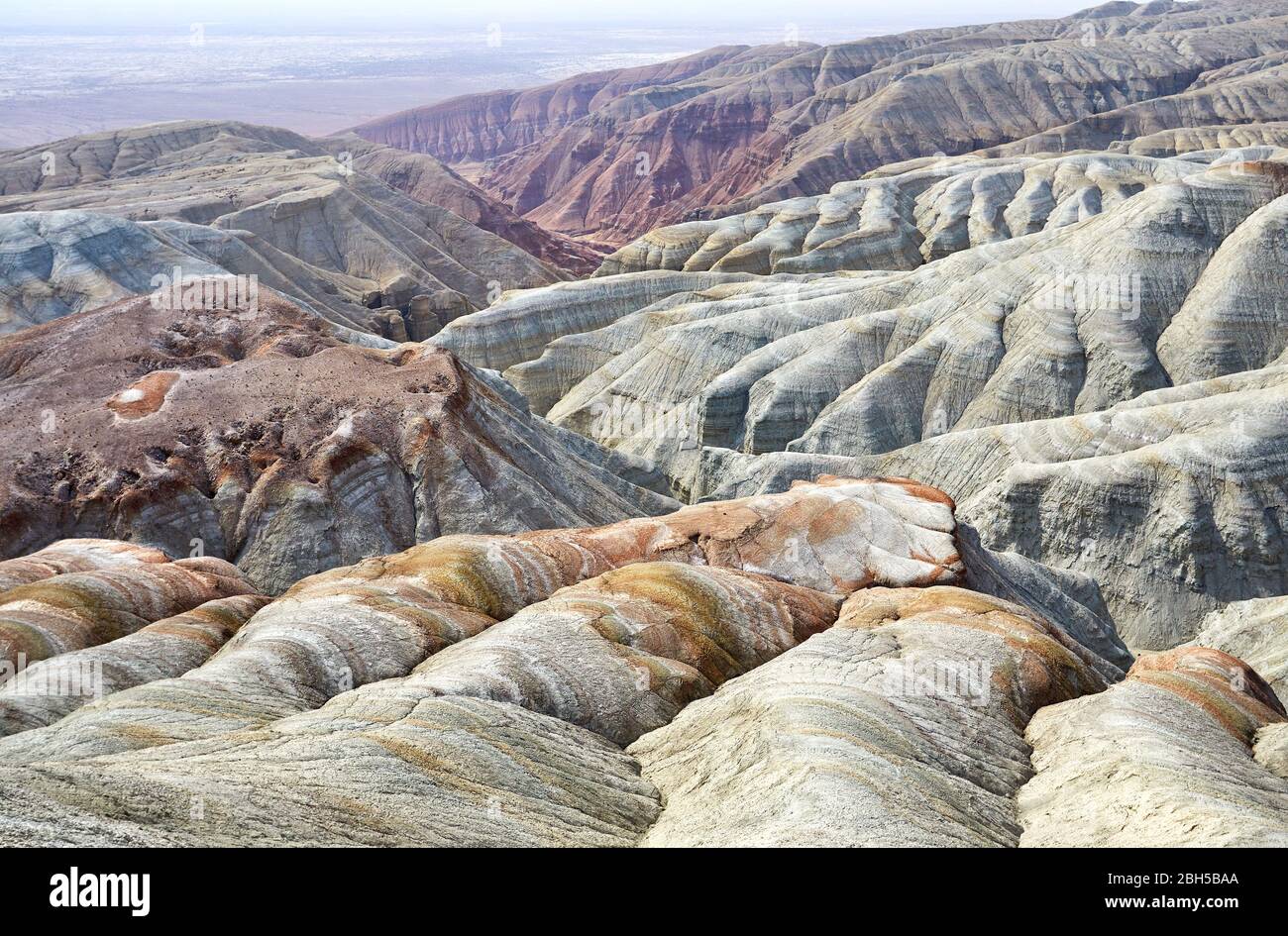Bizarre layered mountains in desert park Altyn Emel in Kazakhstan Stock Photo