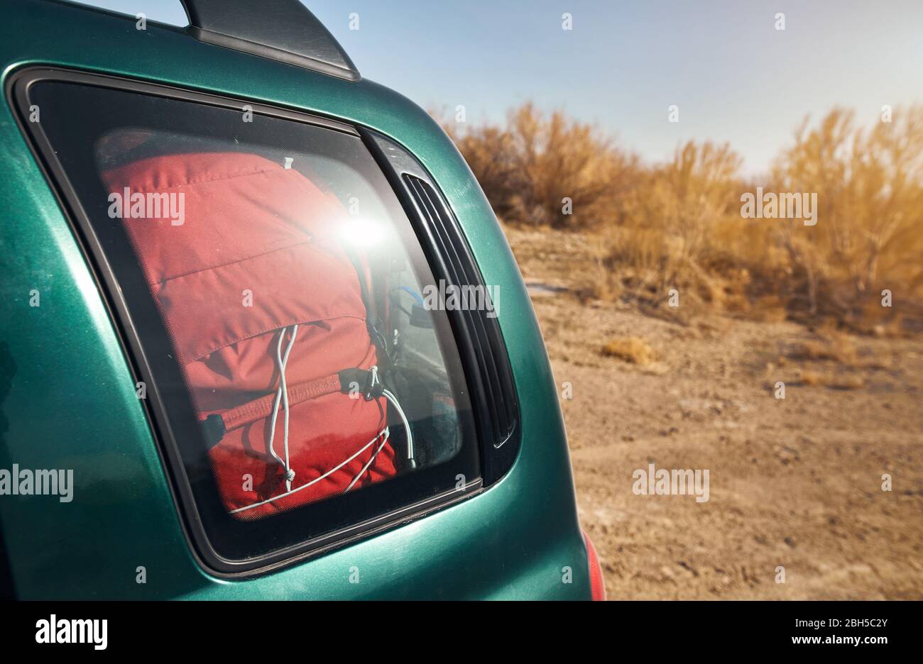 Red backpack in car trunk at the nature background Stock Photo