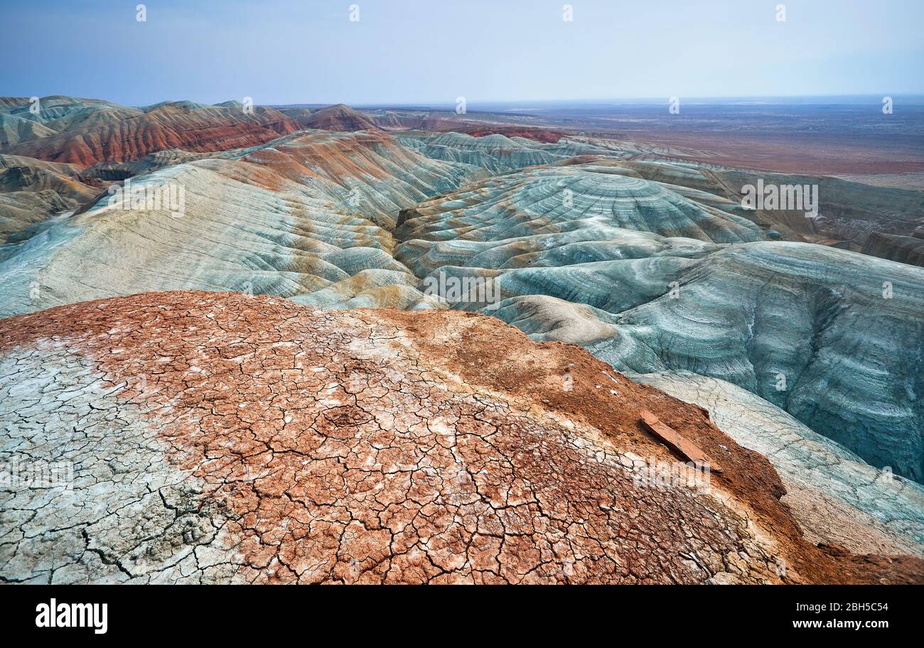 Bizarre layered blue and red mountains in desert park Altyn Emel in Kazakhstan Stock Photo