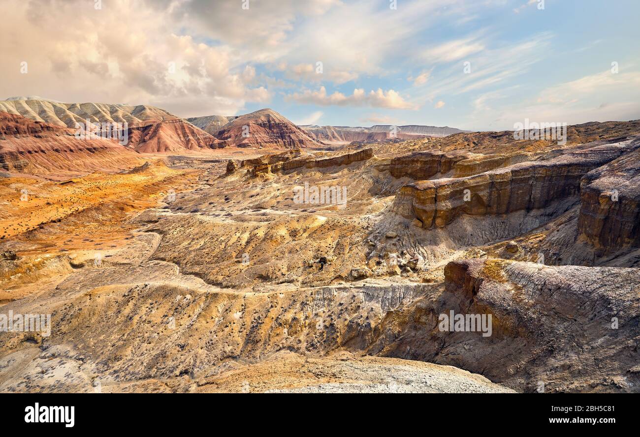 Bizarre layered mountains and Canyons in desert park Altyn Emel in Kazakhstan Stock Photo