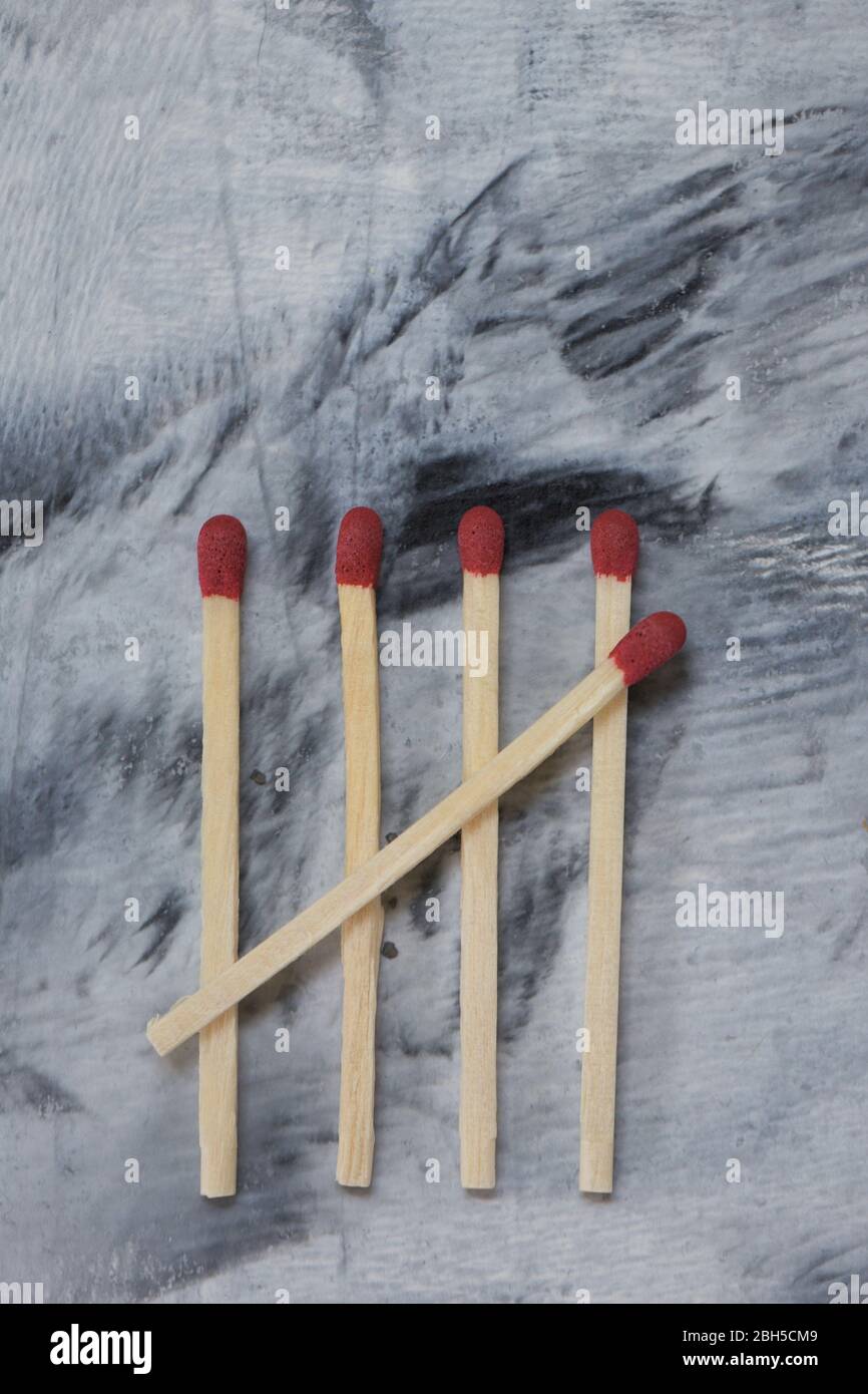 Five matchsticks create tally marks. Stock Photo