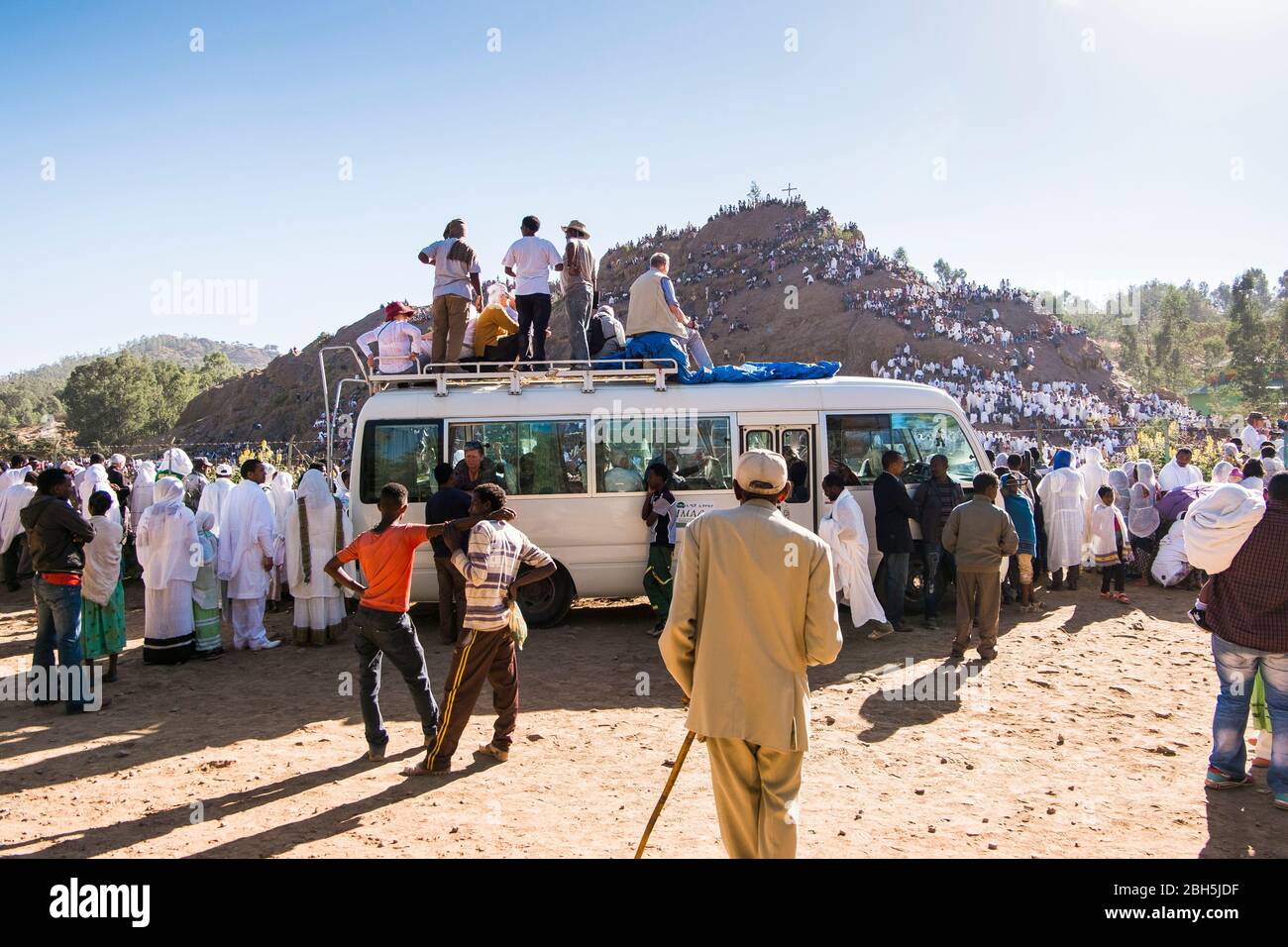 Western tourists sit on their van in order to better witness the Timkat ceremony in Axum. In Ethiopia, Africa. Stock Photo