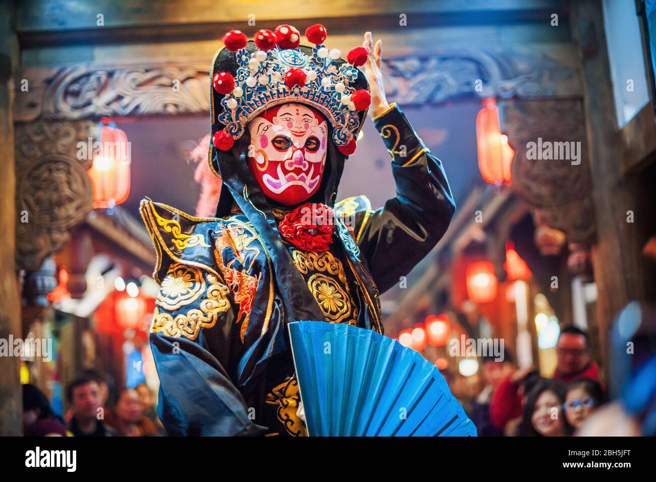 Chengdu, Sichuan Province, China - Jan 29, 2015: Chinese actor performs a public traditional face-changing art or bianlian onstage at Chunxifang Chunxilu covered street. Stock Photo
