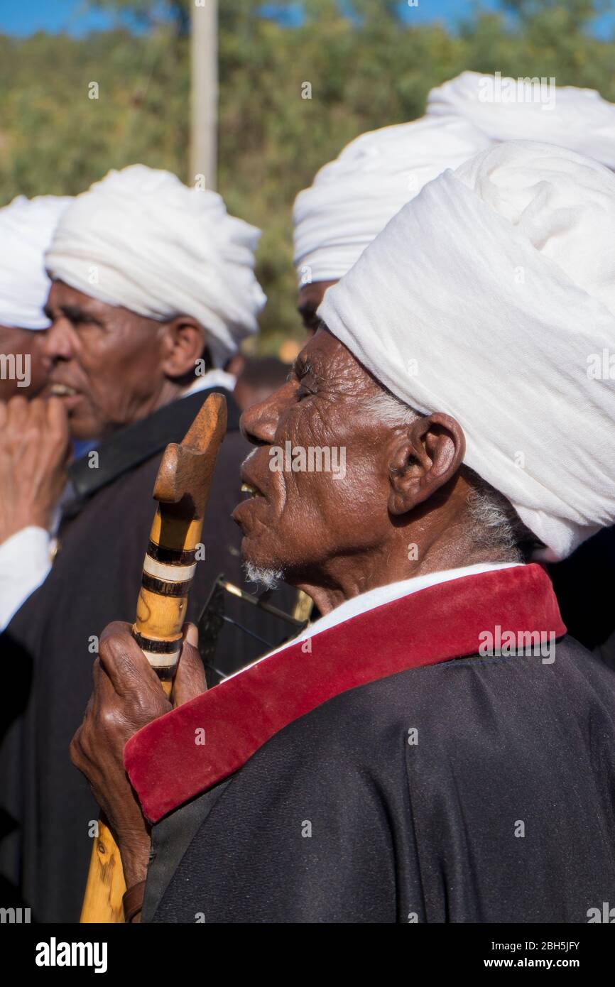 A regally dressed elder, with cane, listens during a Timkat ceremony in Axum. In Ethiopia, Africa. Stock Photo