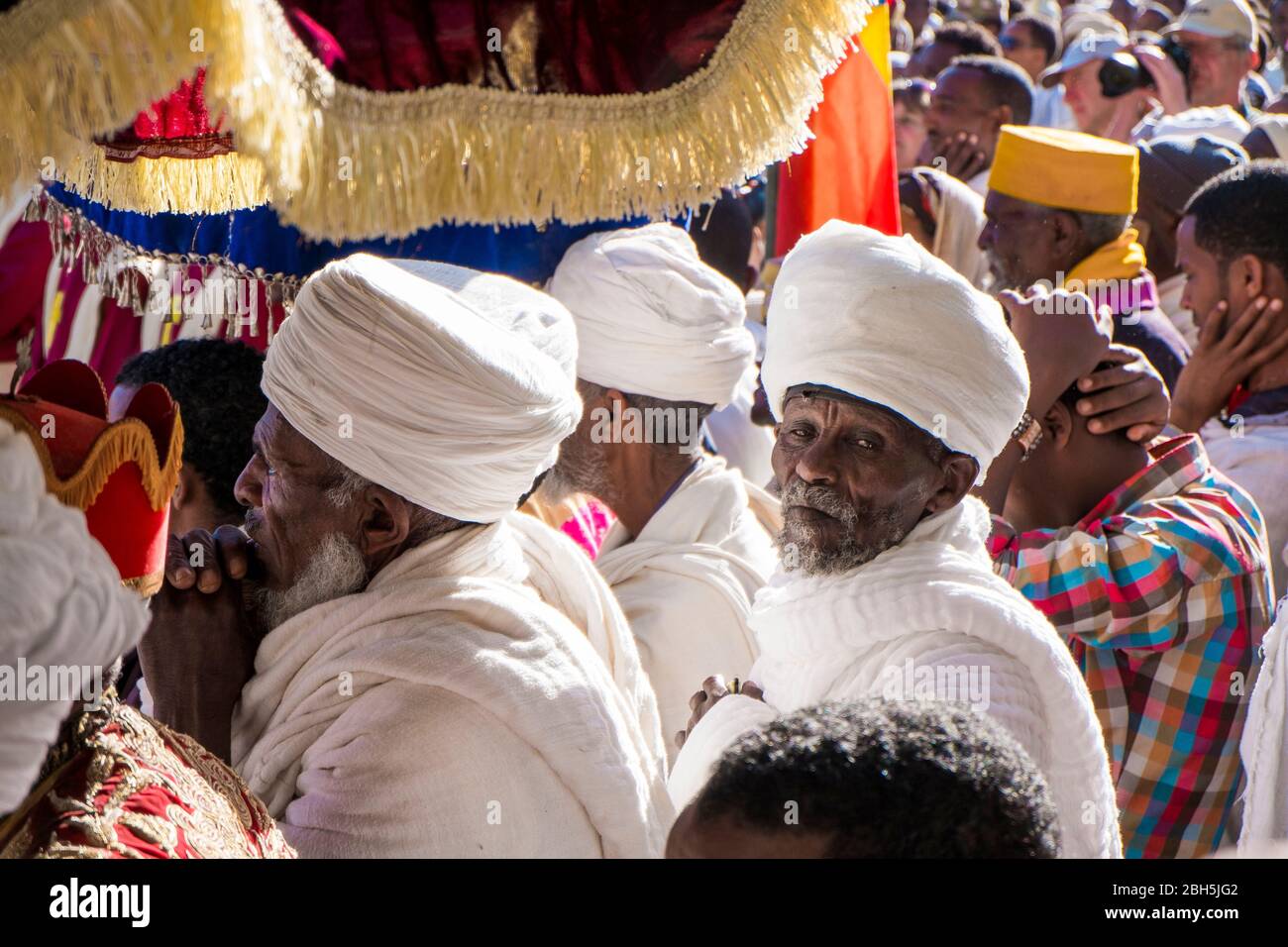 Old men, with wrapped white head turbans, listen during a Timkat ceremony in Axum. In Ethiopia, Africa. Stock Photo
