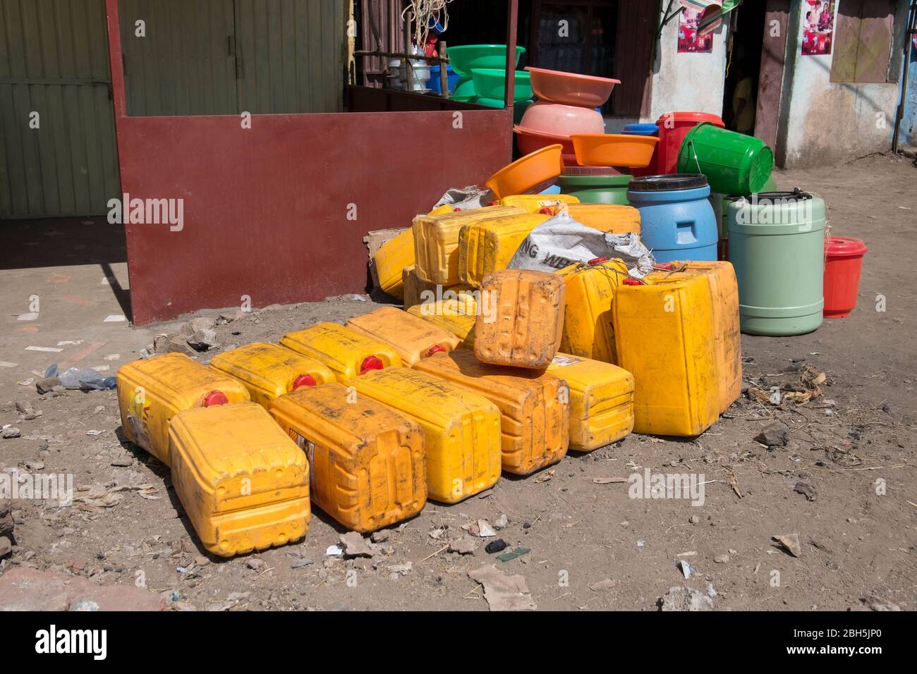 A Pile Of Yellow Plastic Water Jugs Wait To Be Filled The Jugs Are a-pile-of-yellow-plastic-water-jugs-wait-to-be-filled-the-jugs-are