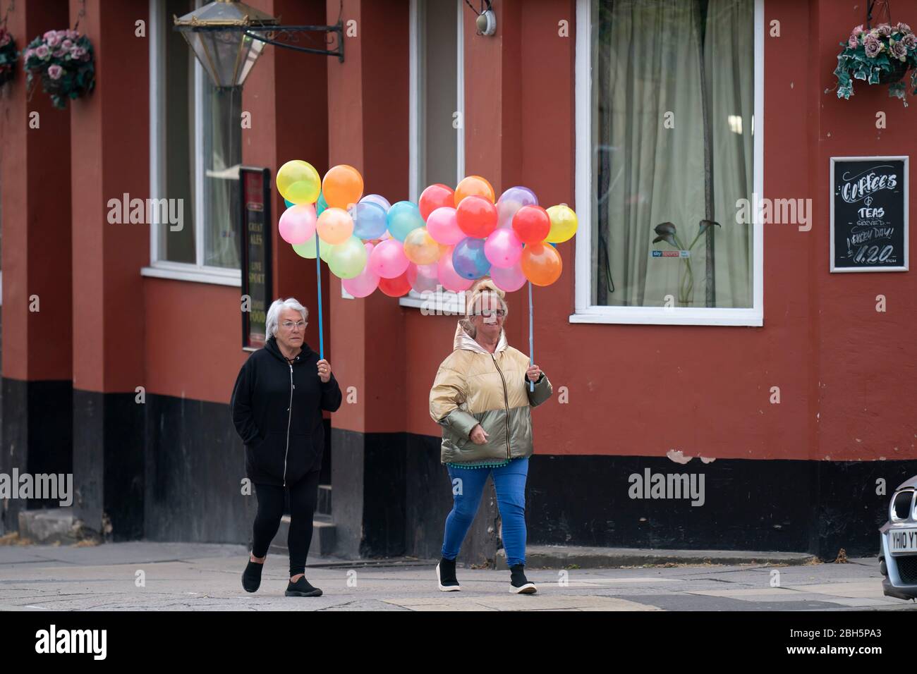 Liverpool. 23rd Apr, 2020. people carrying balloons walk past the Royal