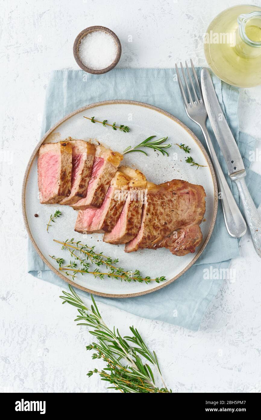 Keto ketogenic diet beef steak, striploin on gray plate on white