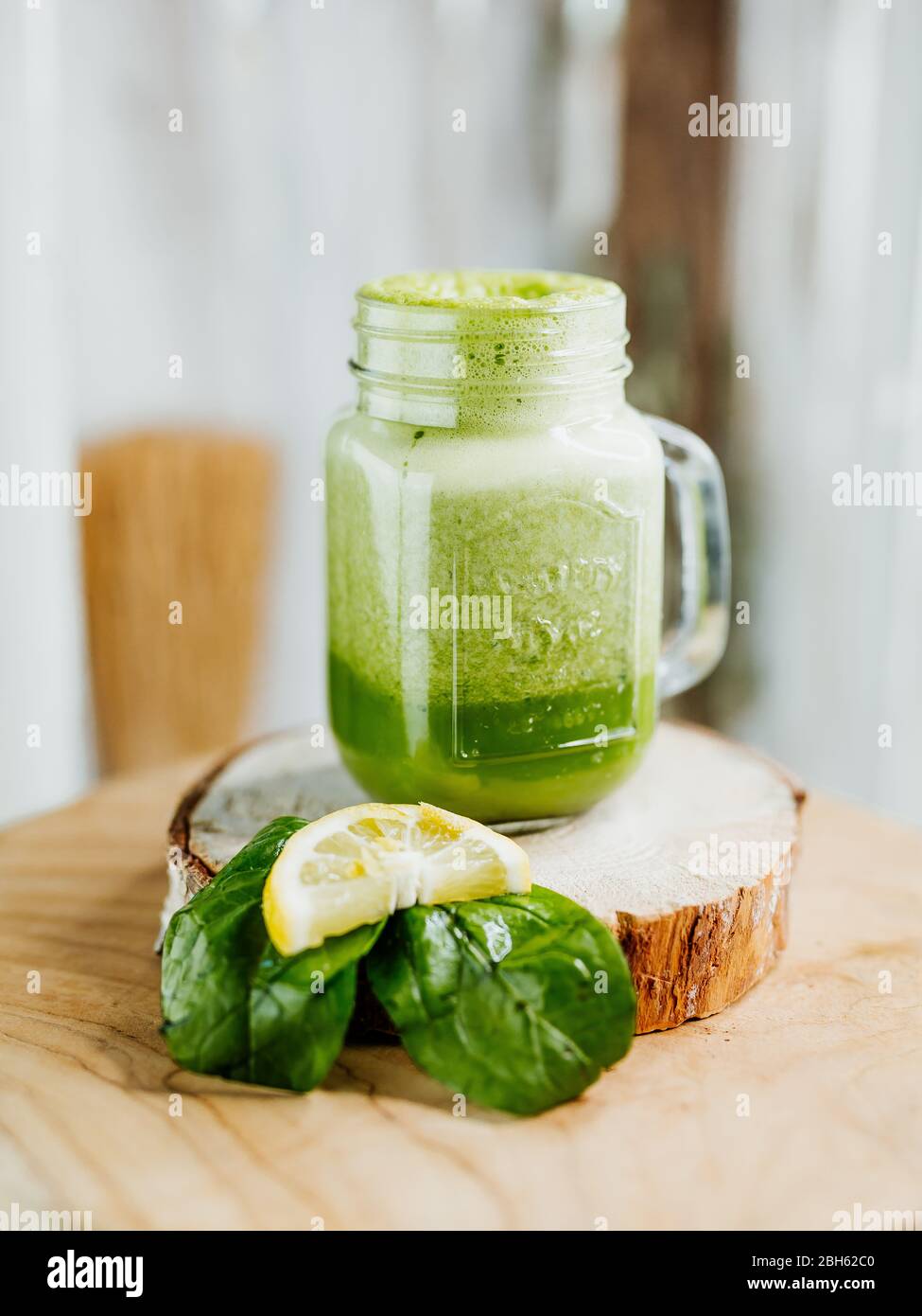 Healthy vitamin shake with spinach, ginger and almond milk in a stylish ...