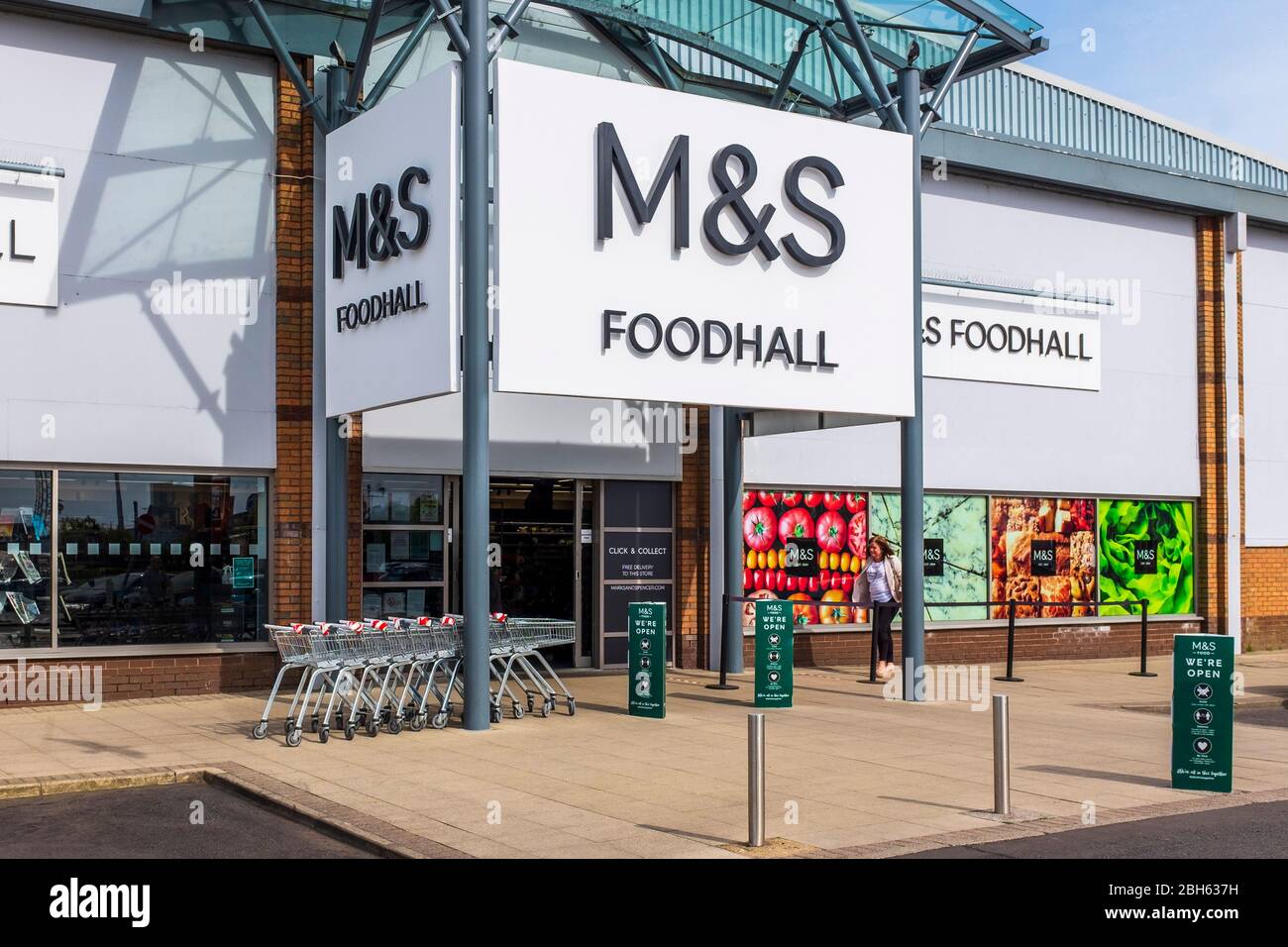 M and S Foodhall entrance with overhead sign and trolleys outside, Irvine, Ayrshire Stock Photo