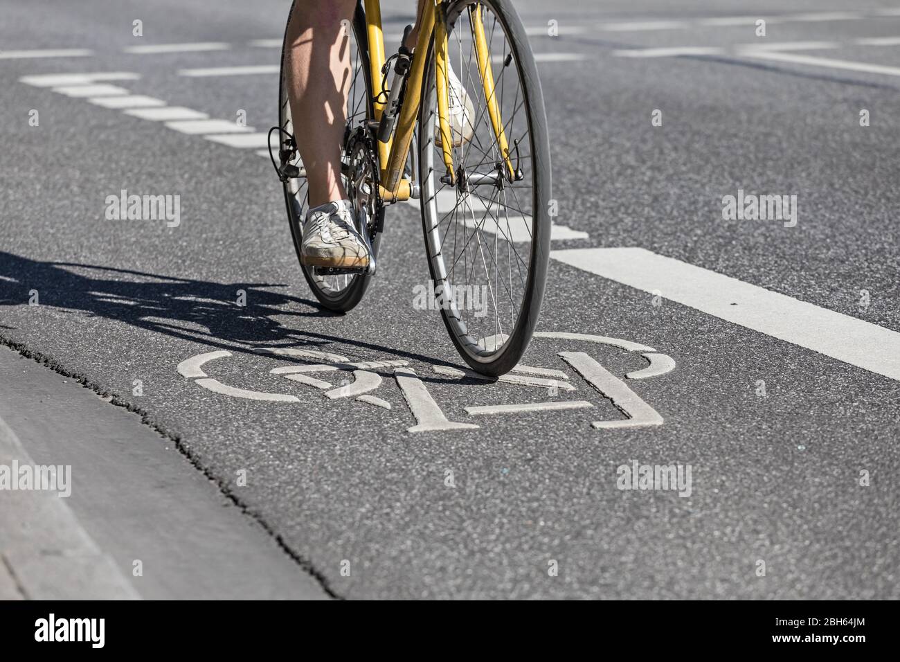 cyclist on painted bike lane Stock Photo