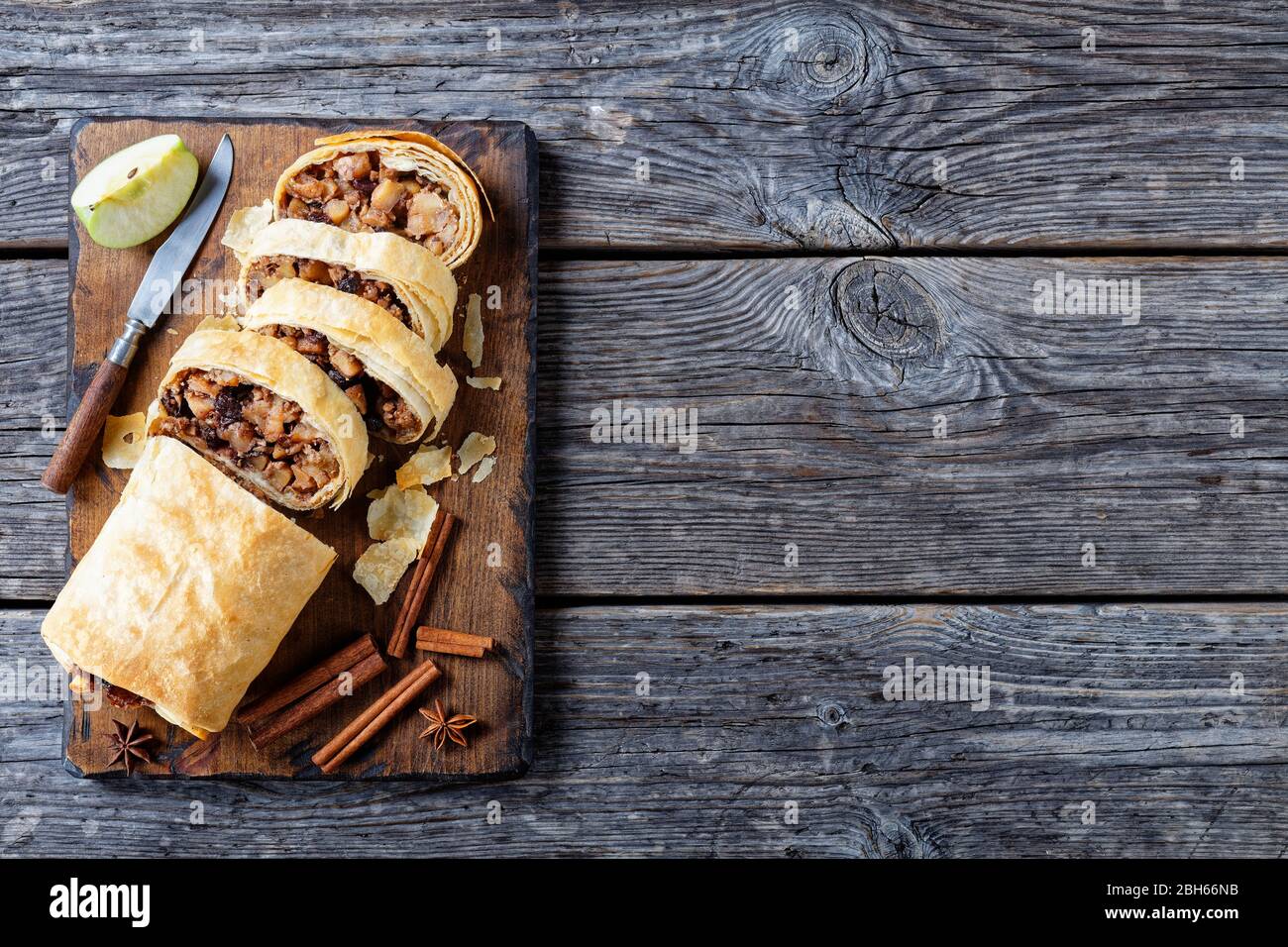 Crispy Baked Austrian Dessert Apple Strudel Of Phyllo Dough With Caramelized Apples Nuts Cinnamon Raisins Served On A Wooden Cutting Board With St Stock Photo Alamy
