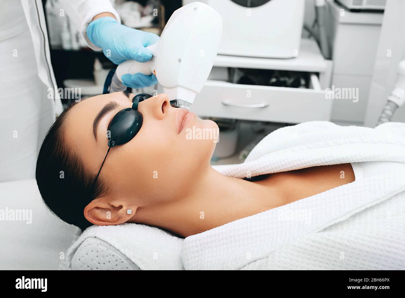 Brunette woman during facial hair removal procedure. Laser hair removal Stock Photo - Alamy Brunette woman during facial hair removal procedure. Laser hair removal Stock Photo - Alamy