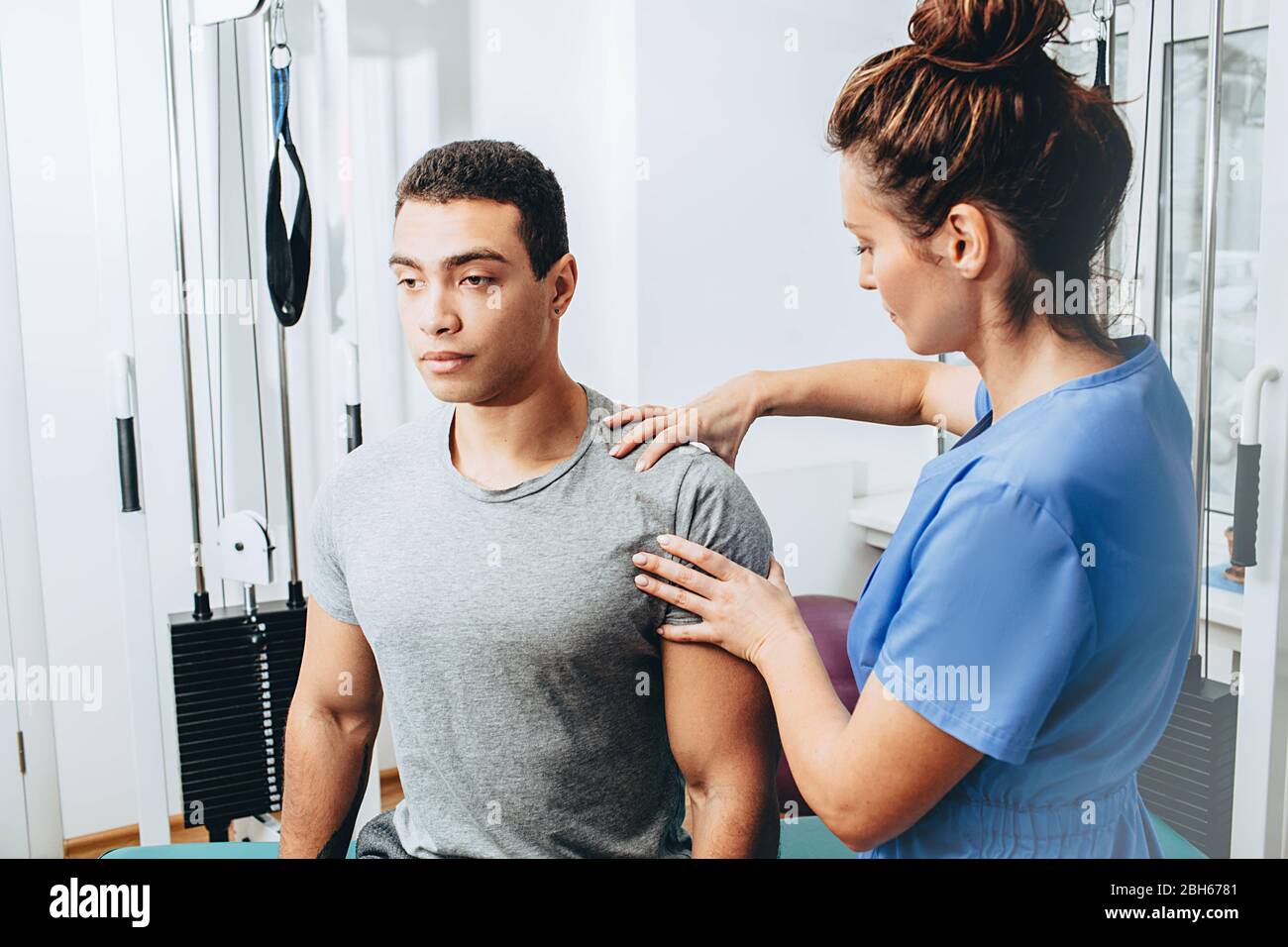 physiotherapist examines a patient with injury of the shoulder joint