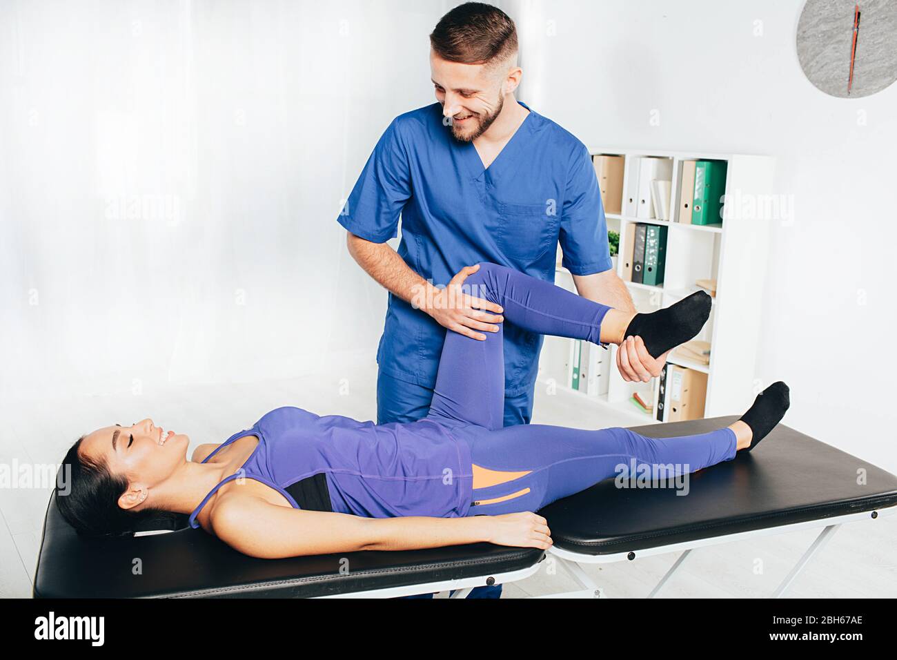 Woman treatment her joint with therapist. Physical therapist helping