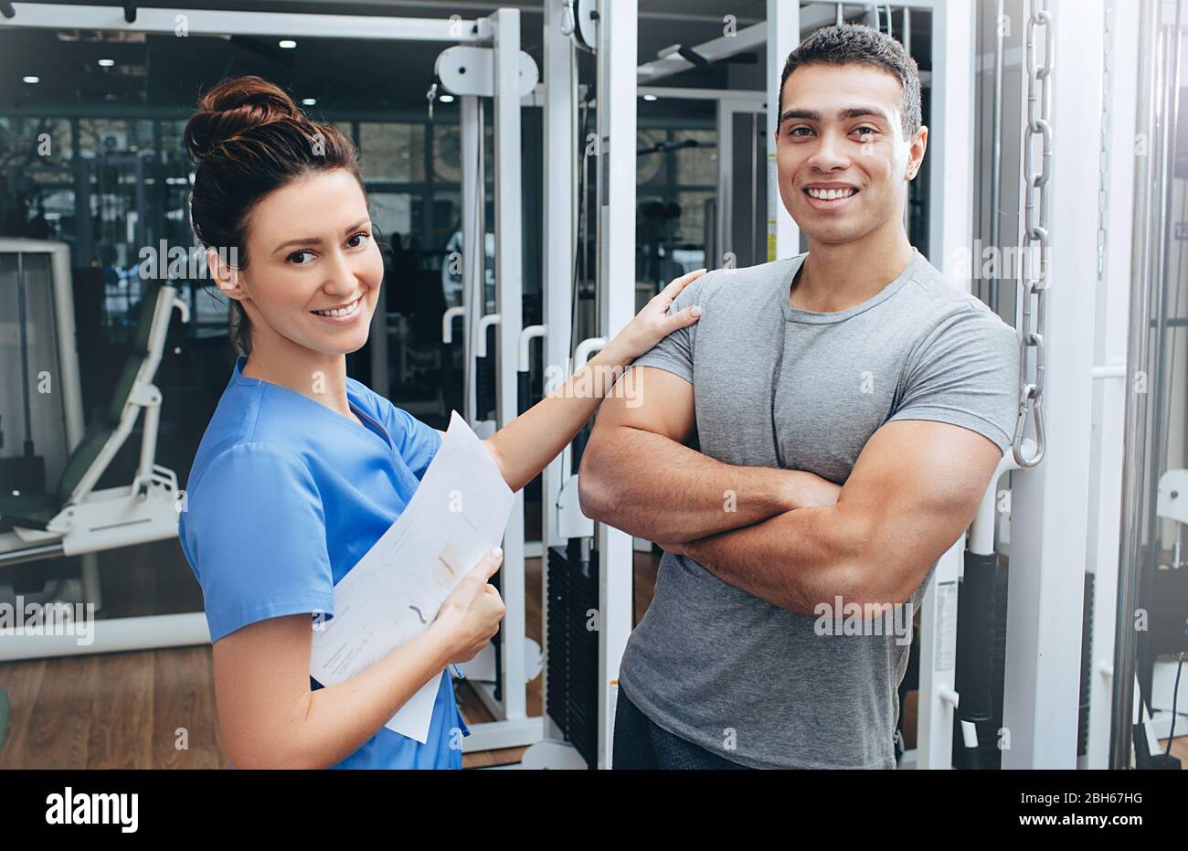 Athlete after treatment at the physiotherapist. A mixed race man is very pleased with the treatment at the rehabilitation center Stock Photo