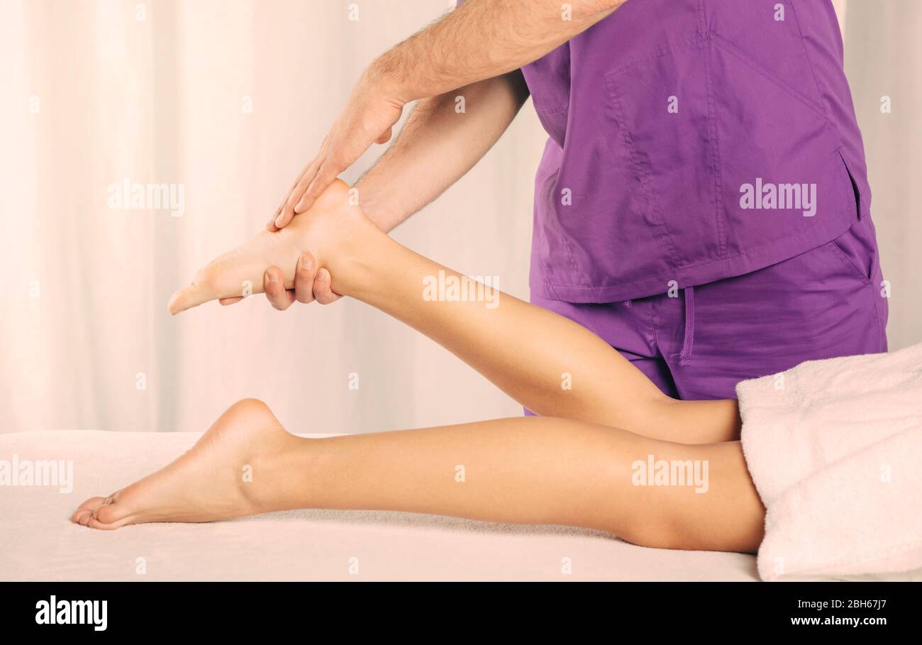 reflexology, foot massage. male masseur massages special points on the female foot. relaxing foot massage Stock Photo