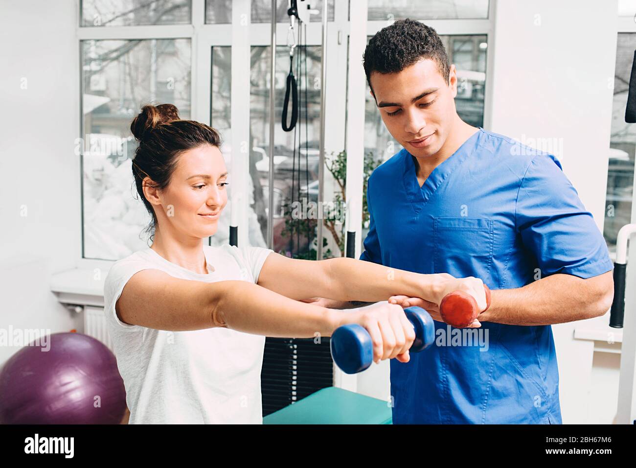woman correctly performs exercise in the gym for the treatment of