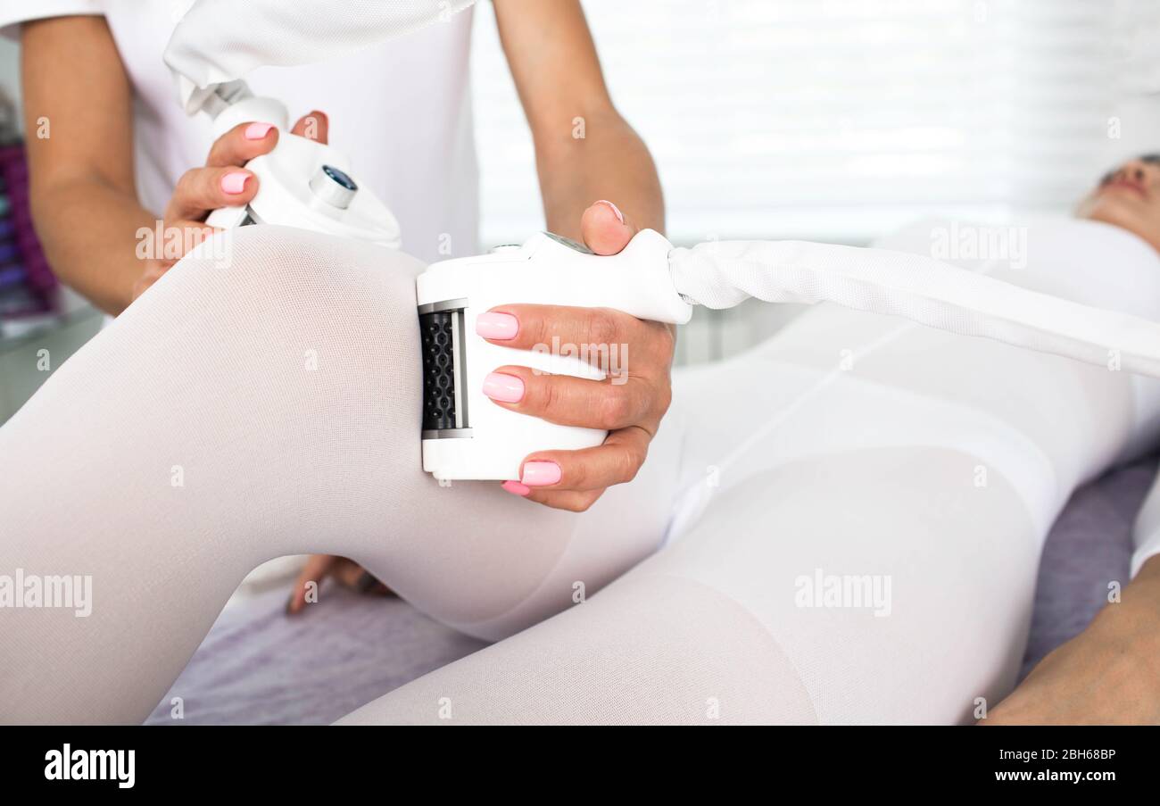 woman receiving lpg massage against cellulite on her leg Stock Photo