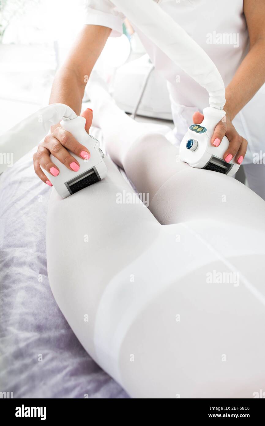 woman receiving lpg massage against cellulite on her leg Stock Photo