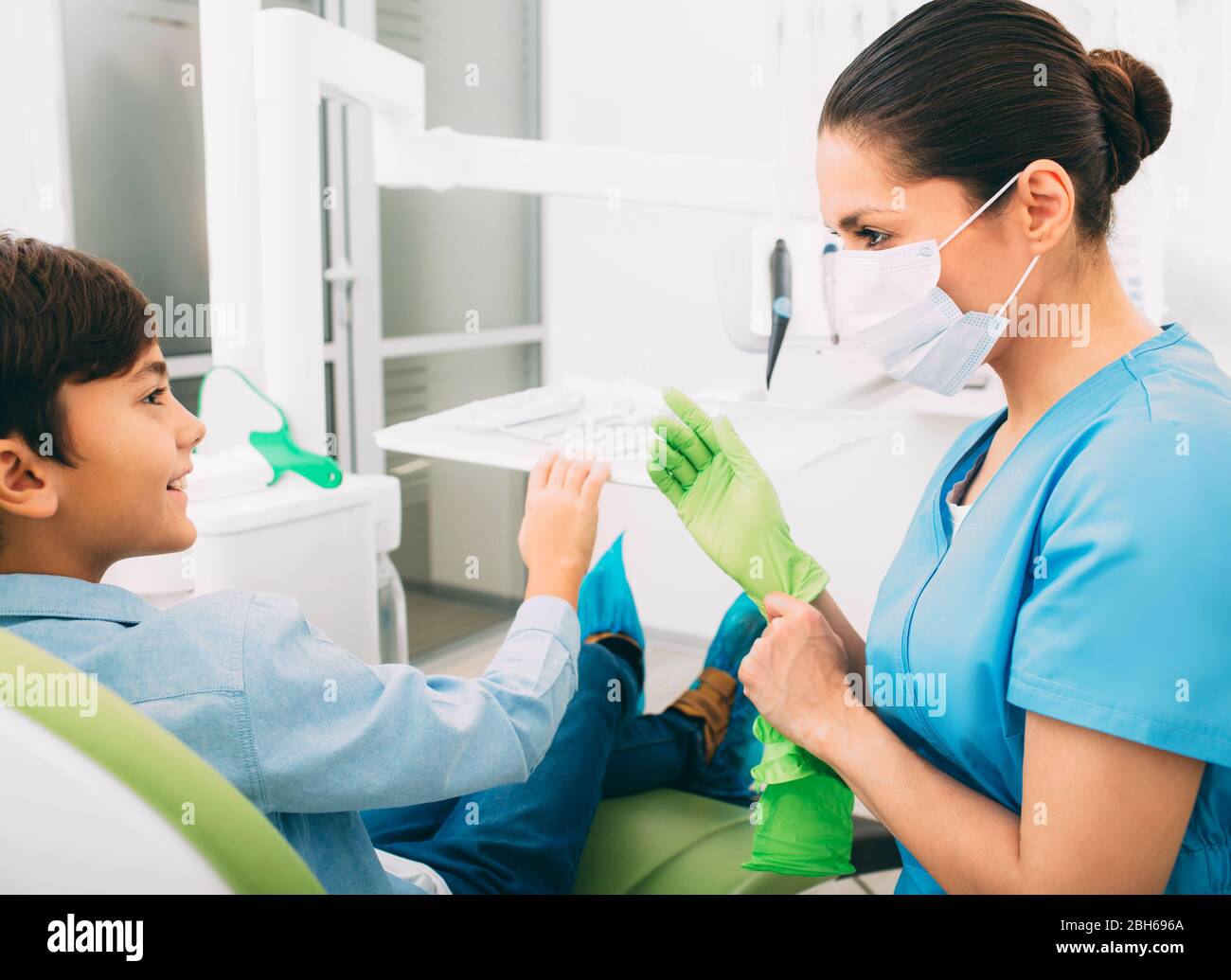 Dentist prepare teeth treatment. Pediatric dentist treat teeth to a little boy Stock Photo