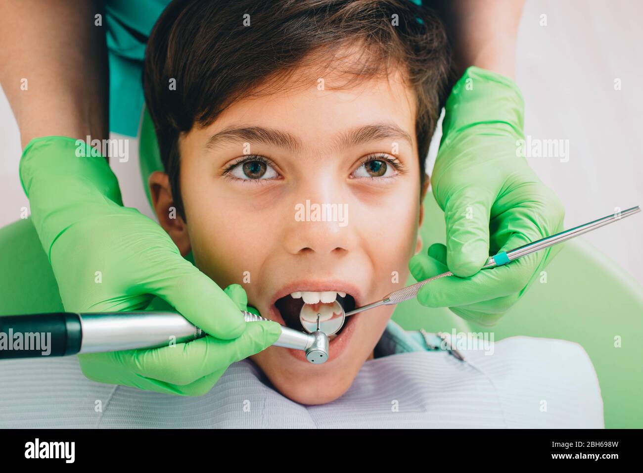 Little boy receiving teeth treatment with dental drill, close-up Stock Photo