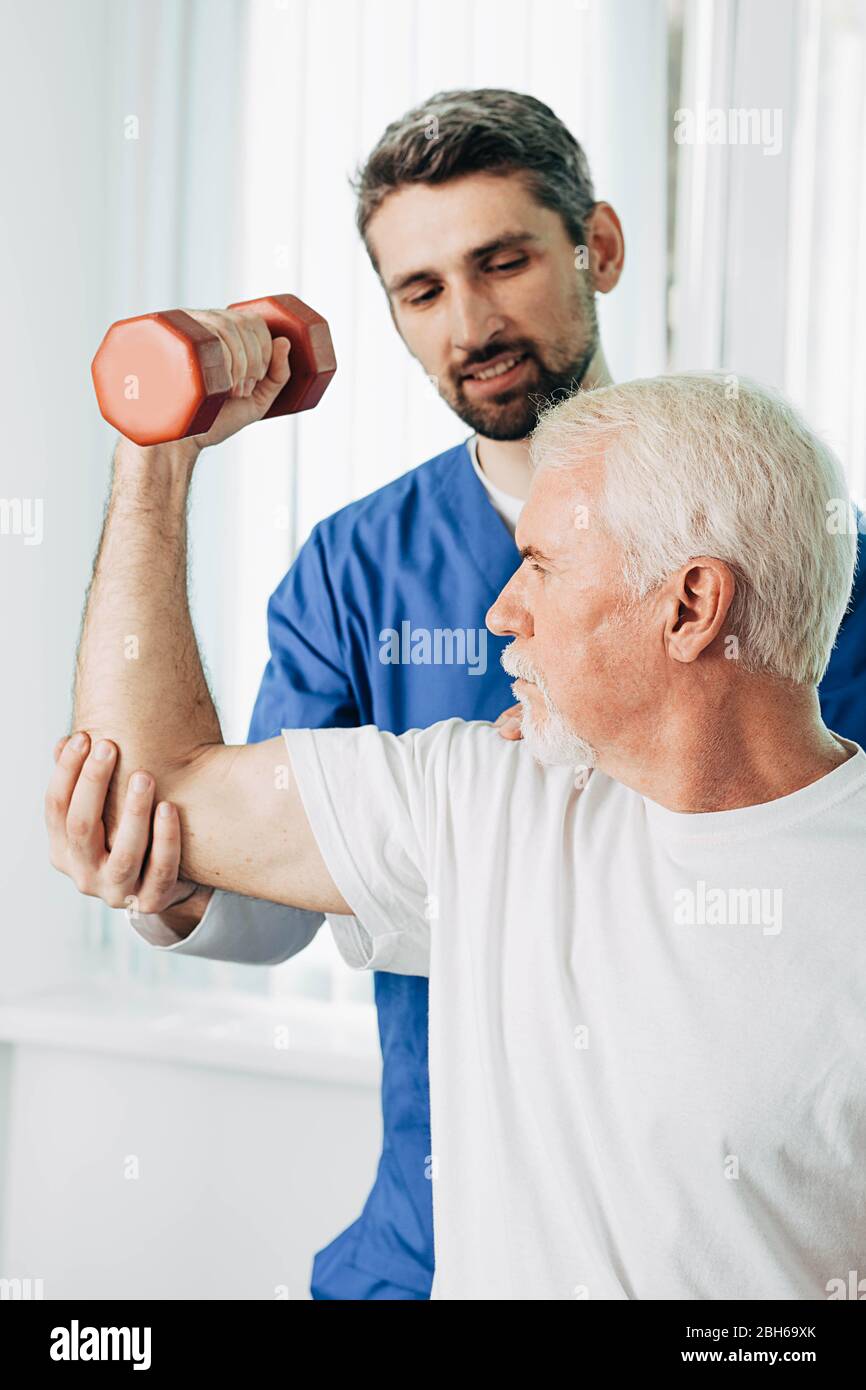 senior man lift a dumbbell, he doing treatment exercise with his