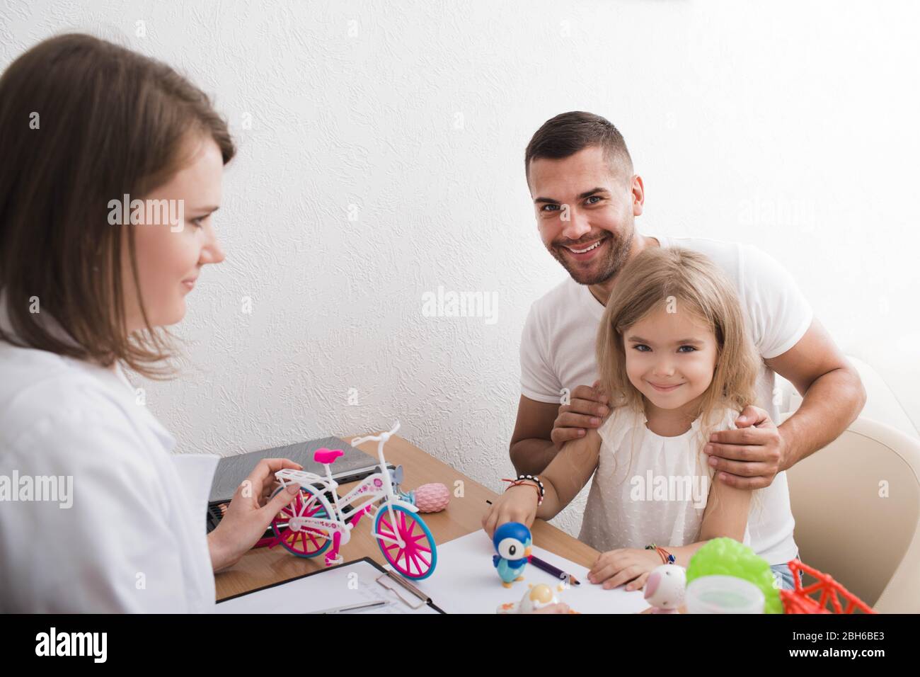 Father with his child at at child psychologist's office. Child psychologist taking care of the Mental Health of the child Stock Photo