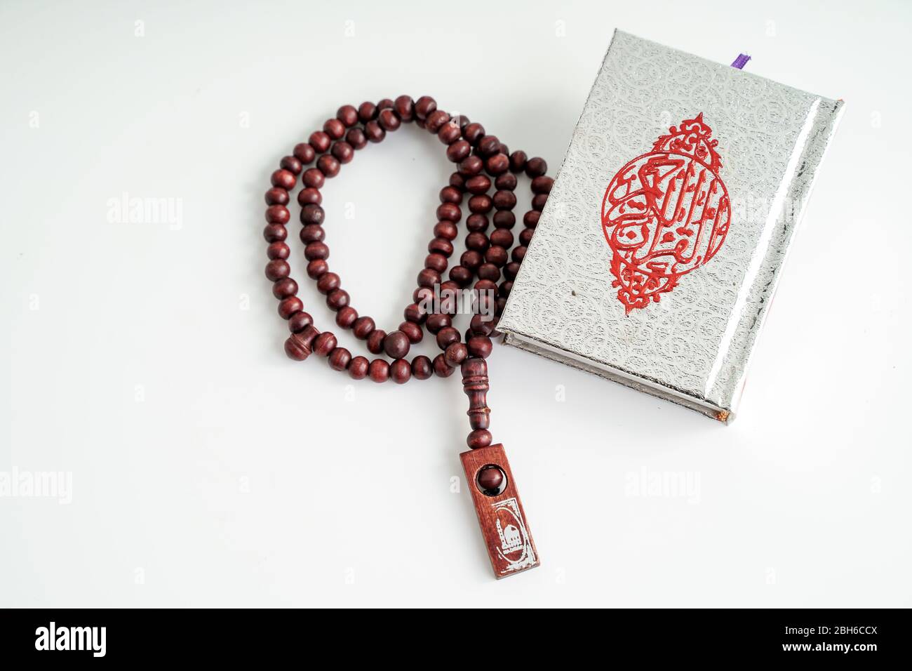 Islamic Holy Book Quran with prayer beads on White Background. Ramadan concept Stock Photo