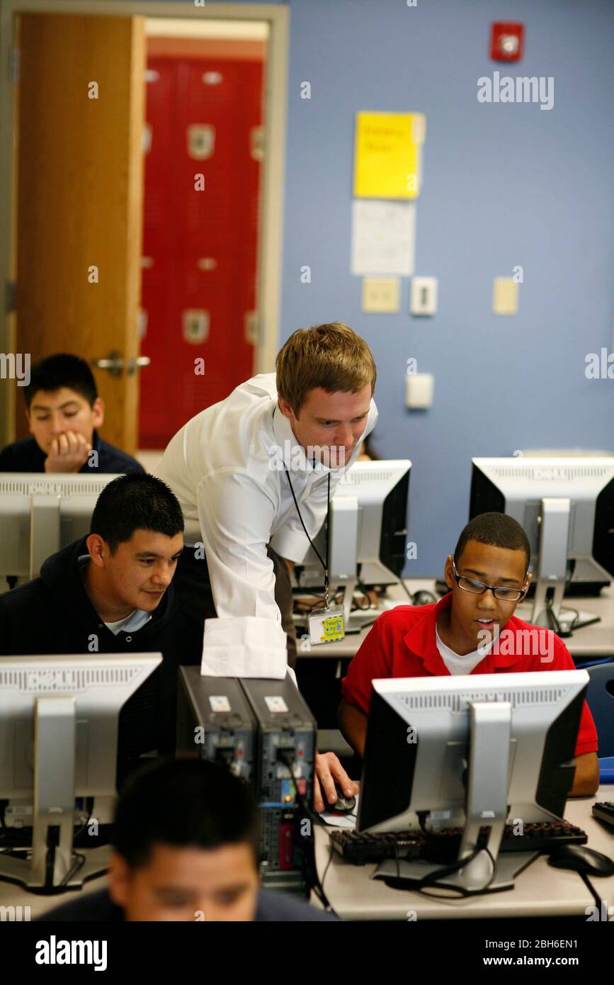 Dallas, Texas, January 23, 2009: Teacher leans in with seventh and ...